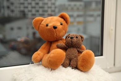 Photo of Teddy bears on window sill at home