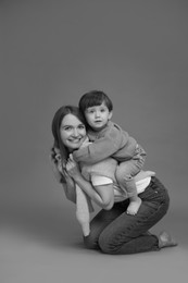 Photo of Happy mother with her little son, black and white effect