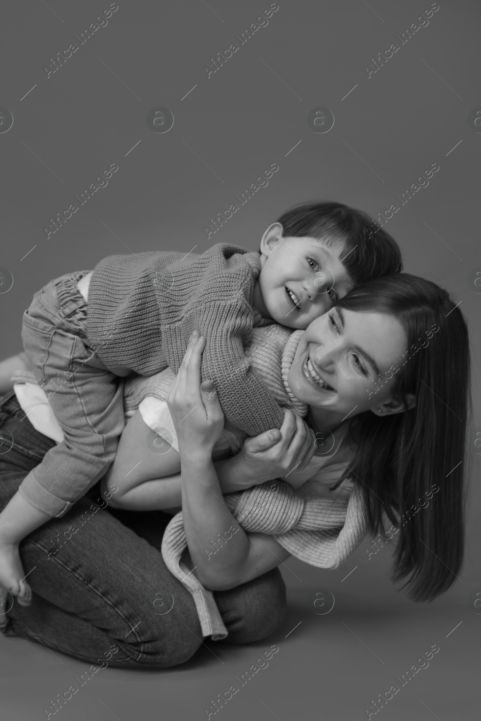 Photo of Happy mother with her little son, black and white effect