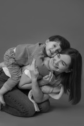 Photo of Happy mother with her little son, black and white effect