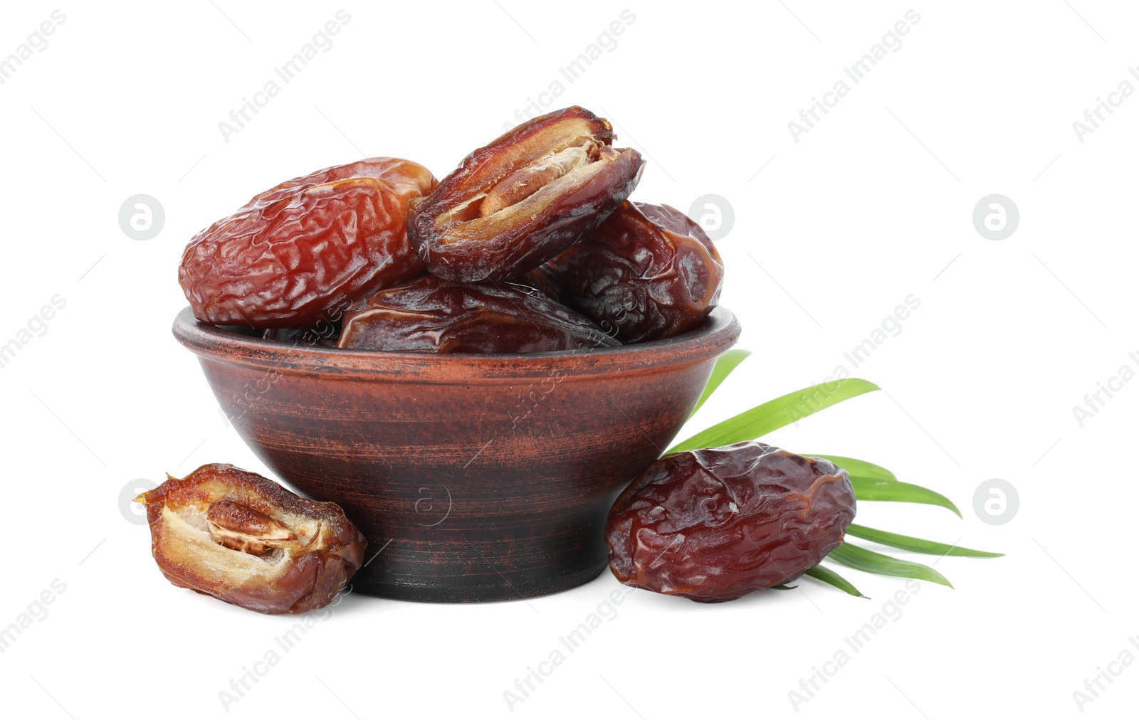 Photo of Tasty dried dates and leaf in bowl isolated on white