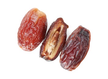 Photo of Three tasty dried dates isolated on white, top view