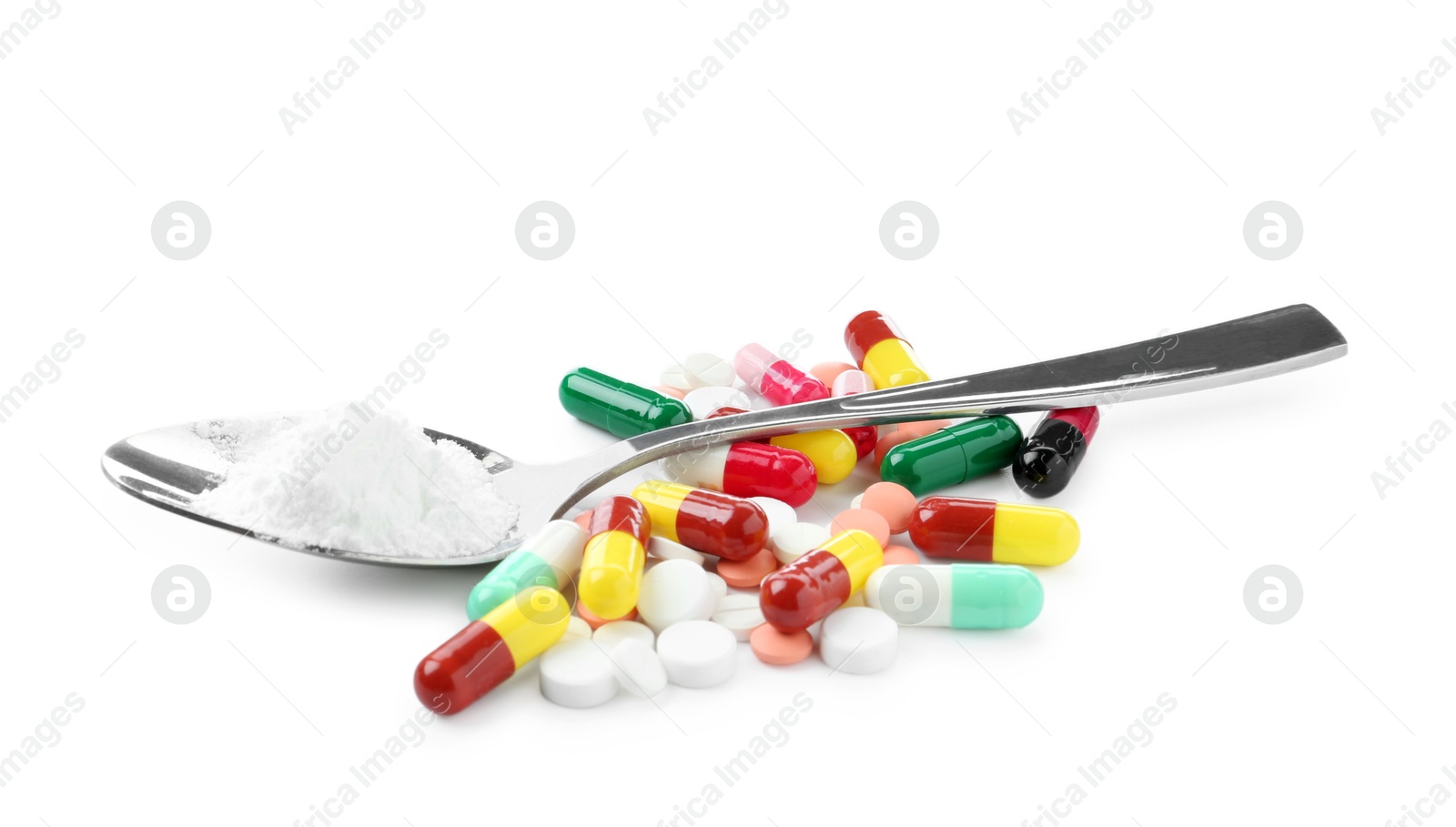 Photo of Drug addiction. Different pills and spoon with powder isolated on white