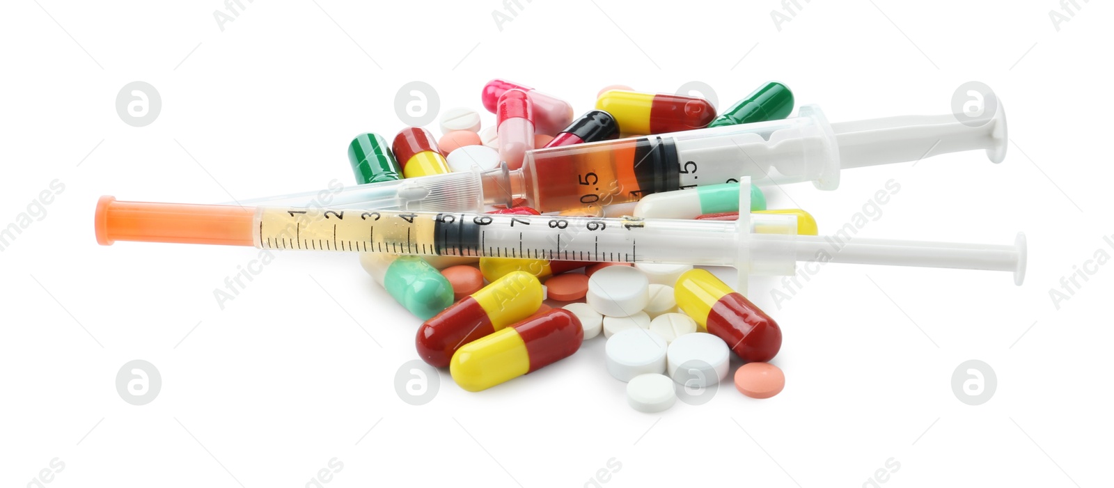 Photo of Drug addiction. Different pills and syringes isolated on white