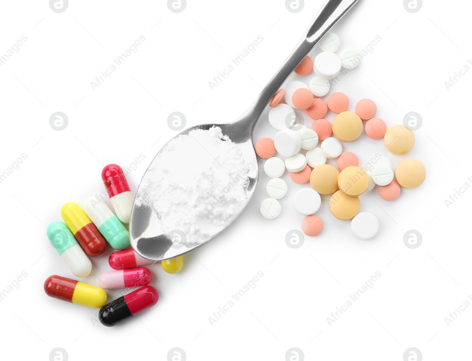 Photo of Drug addiction. Different pills and spoon with powder isolated on white, top view