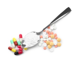 Photo of Drug addiction. Different pills and spoon with powder isolated on white, top view