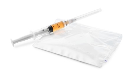 Photo of Drug addiction. Plastic bag with powder and syringe isolated on white