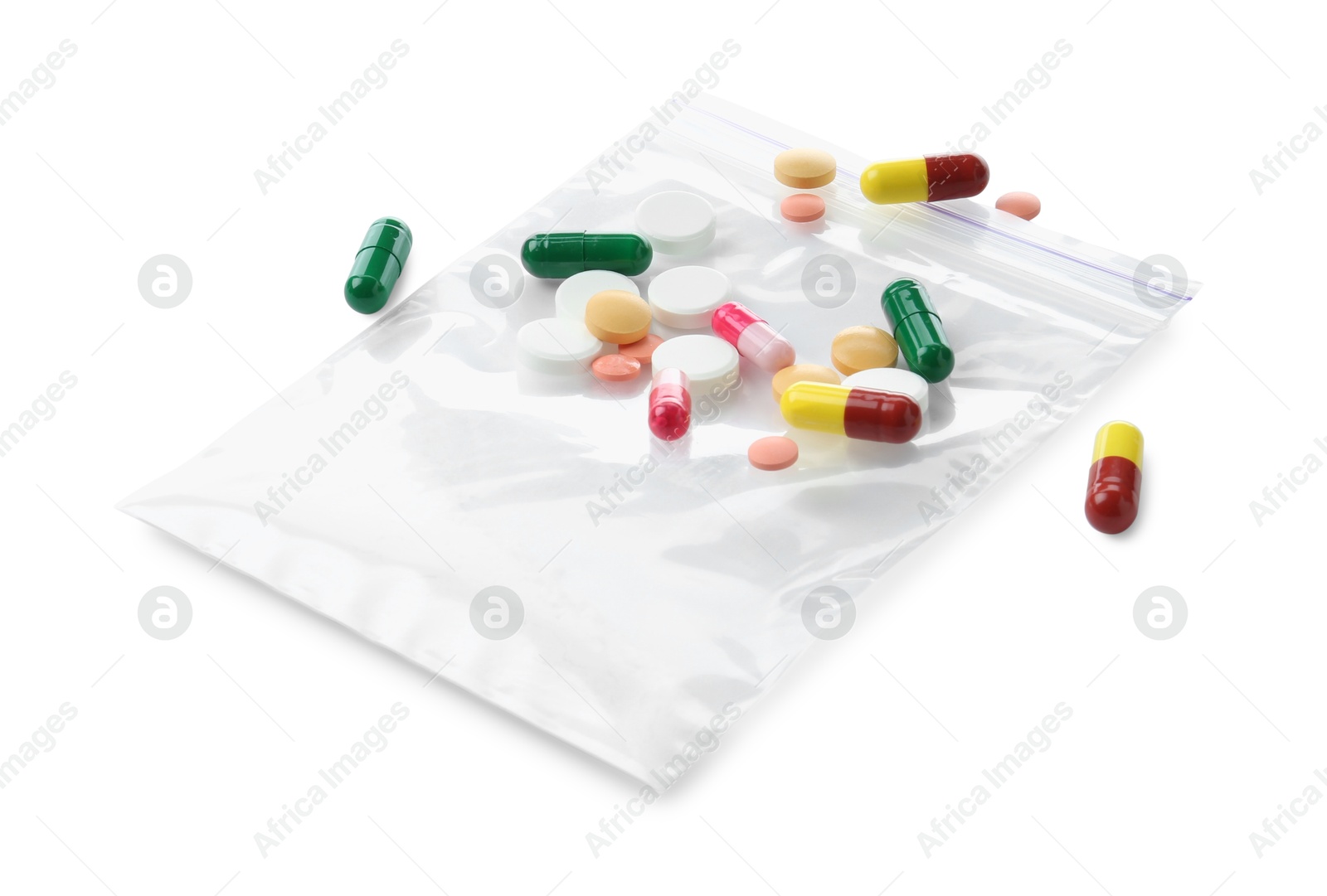 Photo of Drug addiction. Different pills and plastic bag with powder isolated on white