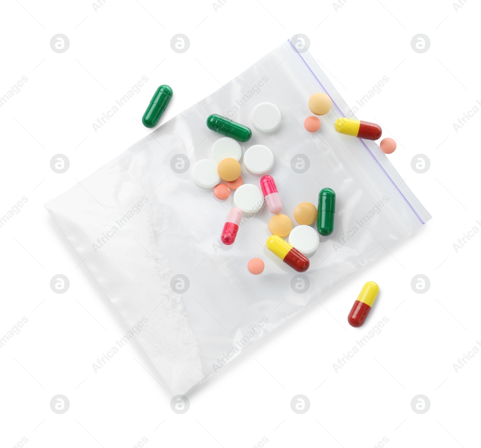 Photo of Drug addiction. Different pills and plastic bag with powder isolated on white, top view