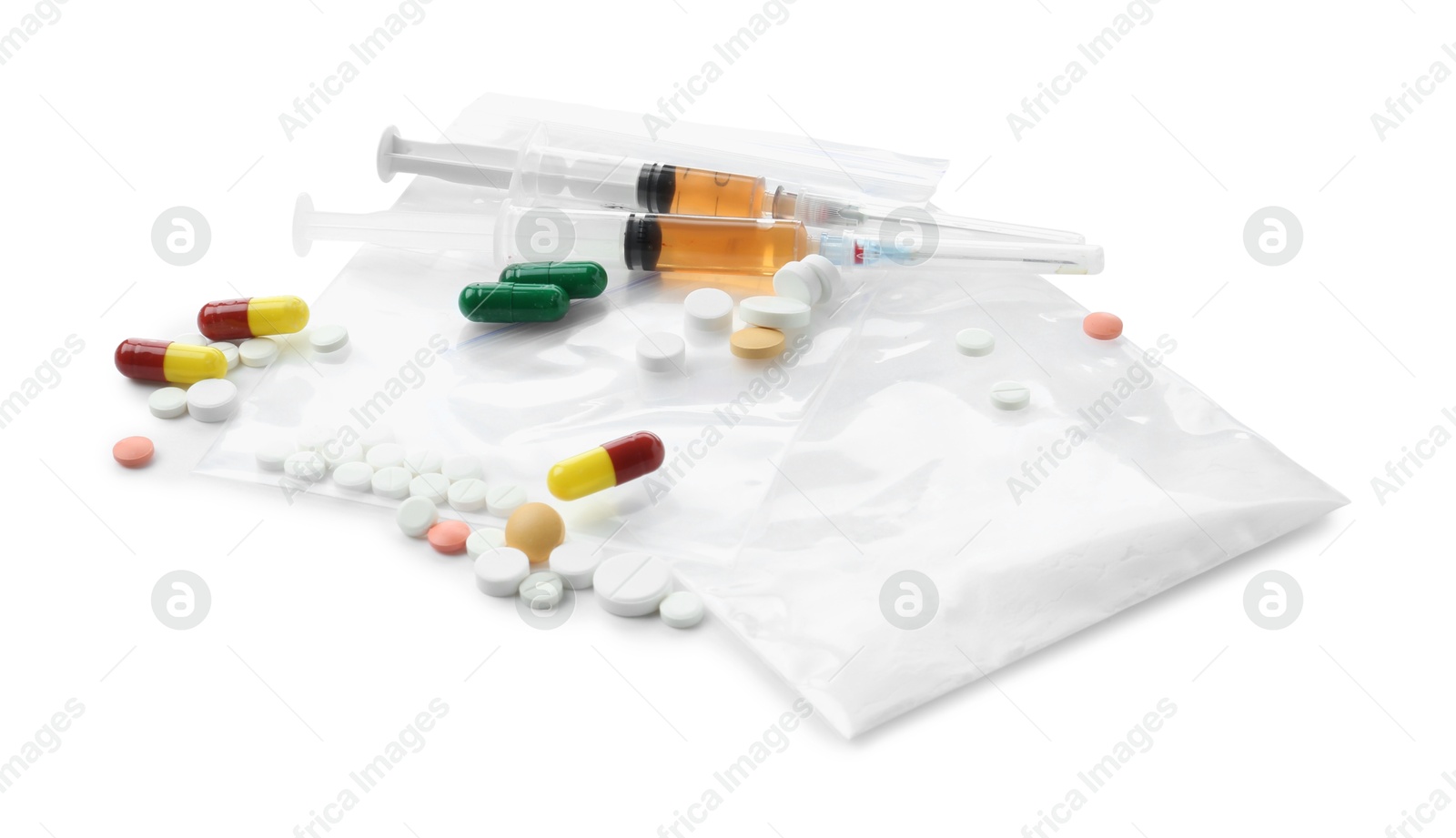 Photo of Drug addiction. Different pills, plastic bags with powder and syringes isolated on white