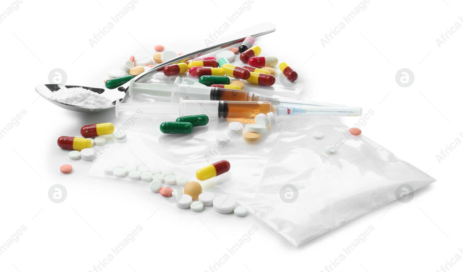 Photo of Drug addiction. Different pills, plastic bag with powder, spoon and syringes isolated on white