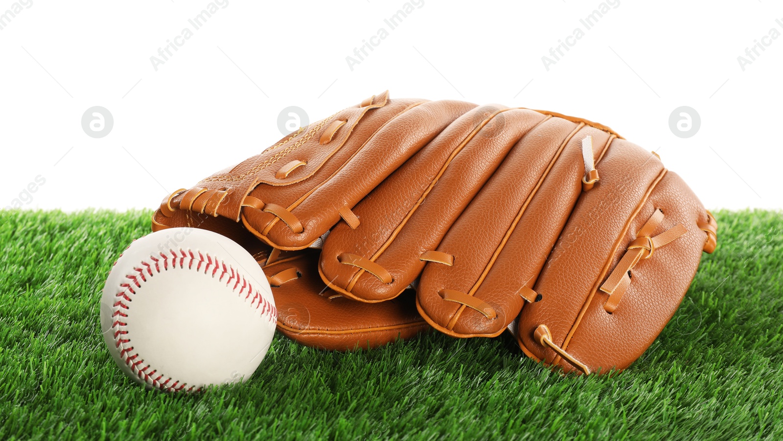 Photo of Baseball mitten and ball on artificial grass isolated on white. Sport equipment