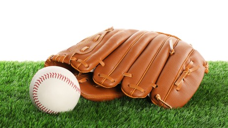 Photo of Baseball mitten and ball on artificial grass isolated on white. Sport equipment