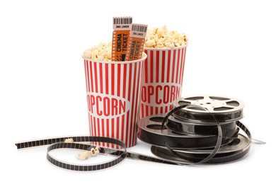 Photo of Tasty popcorn, film reels and movie tickets isolated on white