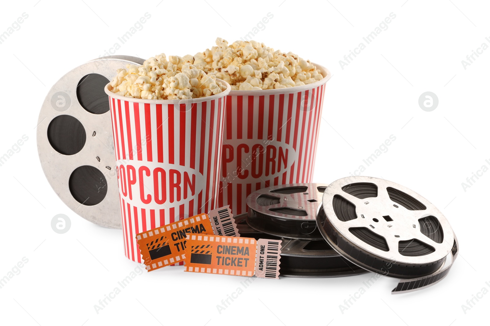 Photo of Tasty popcorn, film reels and movie tickets isolated on white