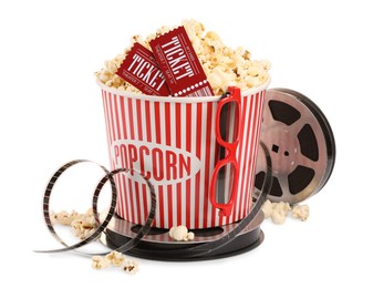 Photo of Tasty popcorn, film reel, glasses and movie tickets isolated on white