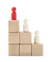 Photo of Human figures on wooden blocks, red one on top against white background. Competition concept