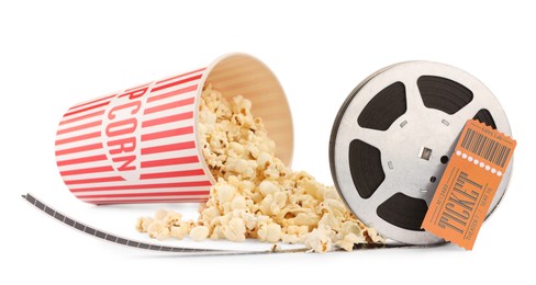 Photo of Tasty popcorn, film reel and movie ticket isolated on white