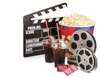 Photo of Tasty popcorn, film reels, clapper, soda drinks and movie tickets isolated on white