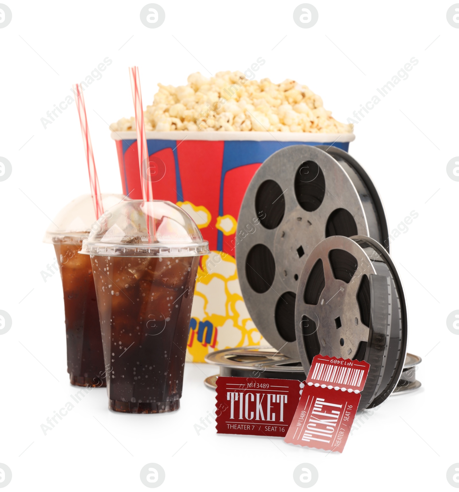 Photo of Tasty popcorn, film reels, soda drinks and movie tickets isolated on white