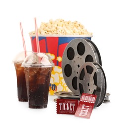 Photo of Tasty popcorn, film reels, soda drinks and movie tickets isolated on white