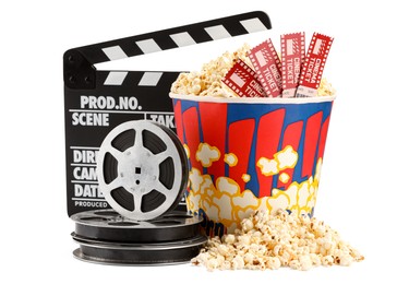 Photo of Tasty popcorn, movie tickets, clapper and film reels isolated on white