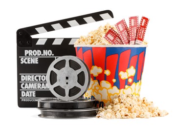 Tasty popcorn, movie tickets, clapper and film reels isolated on white