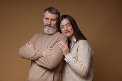 Photo of Family portrait of father and his daughter on brown background