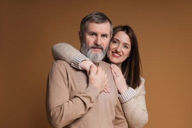 Photo of Family portrait of happy daughter and her father on brown background