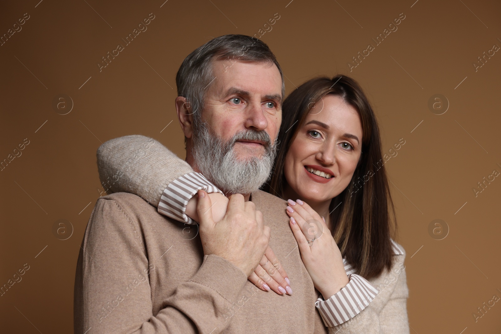 Photo of Family portrait of happy daughter and her father on brown background