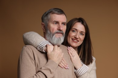 Photo of Family portrait of happy daughter and her father on brown background