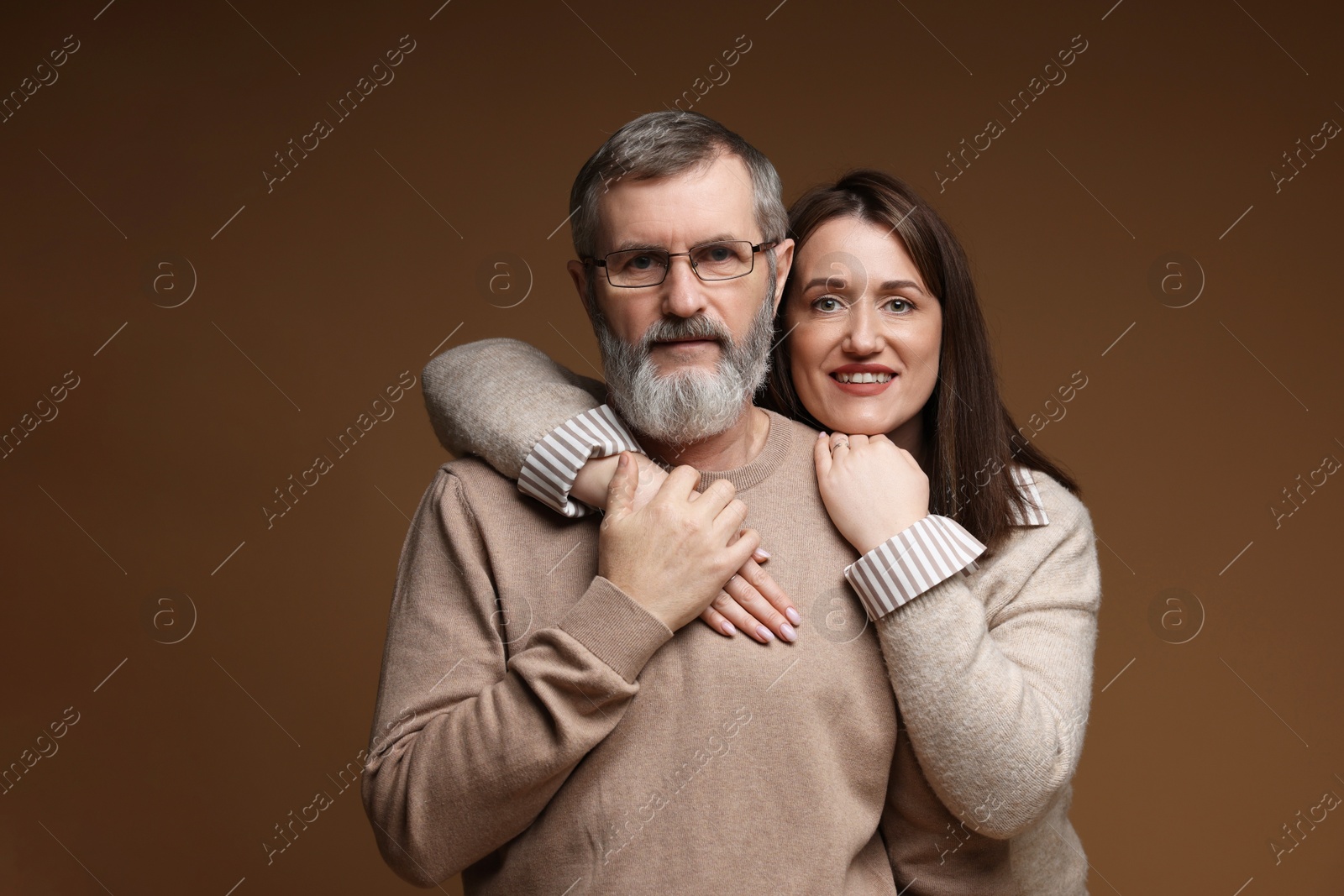 Photo of Family portrait of happy daughter and her father on brown background