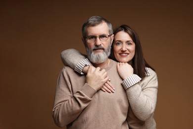 Photo of Family portrait of happy daughter and her father on brown background