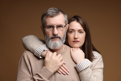 Photo of Family portrait of father and his daughter on brown background