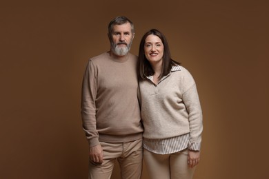 Photo of Family portrait of happy daughter and her father on brown background