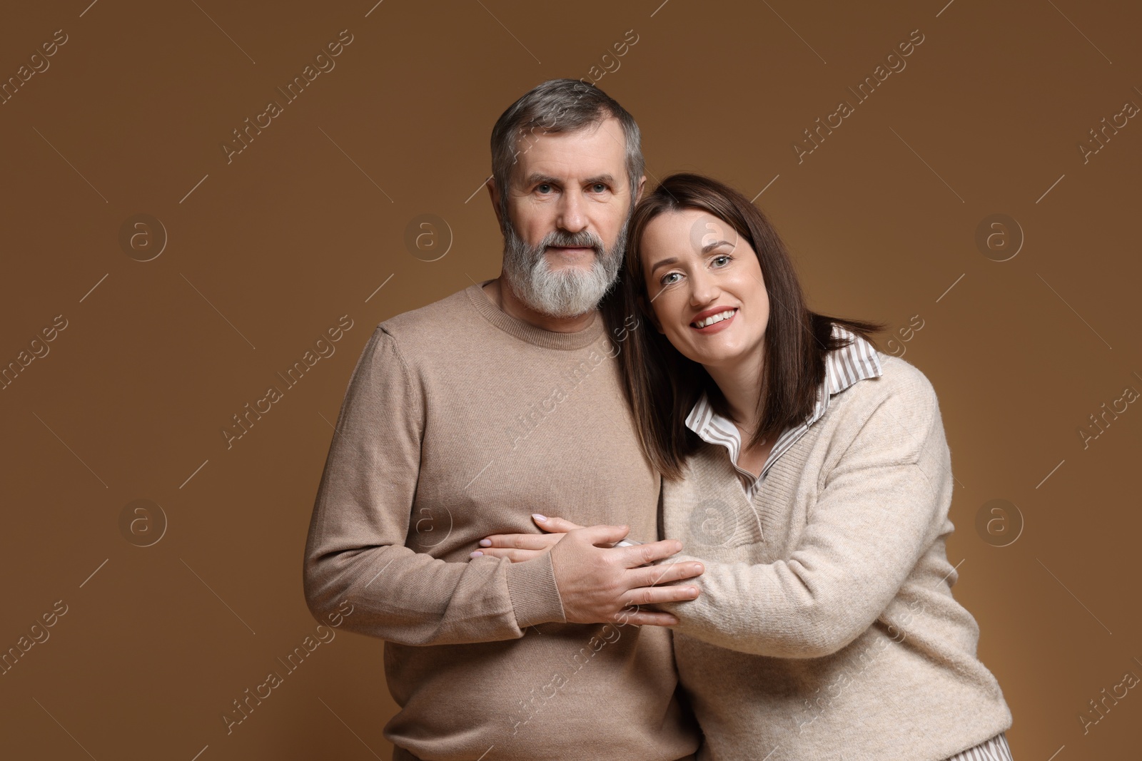 Photo of Family portrait of happy daughter and her father on brown background, space for text