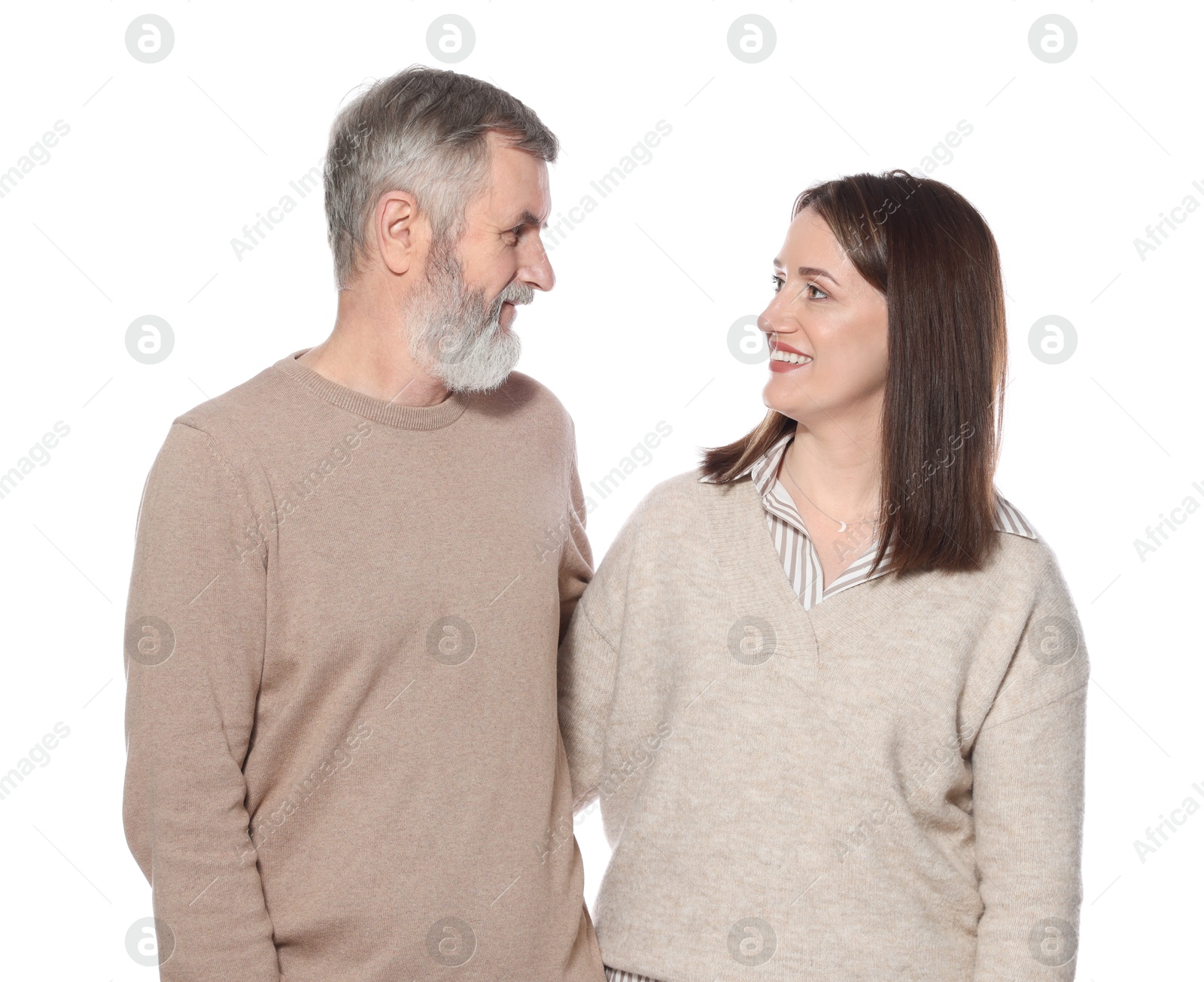 Photo of Happy daughter and her father looking at each other on white background