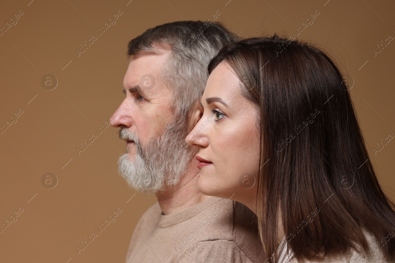 Photo of Daughter and her father on brown background