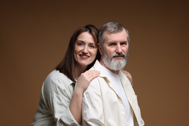 Photo of Family portrait of happy daughter and her father on brown background