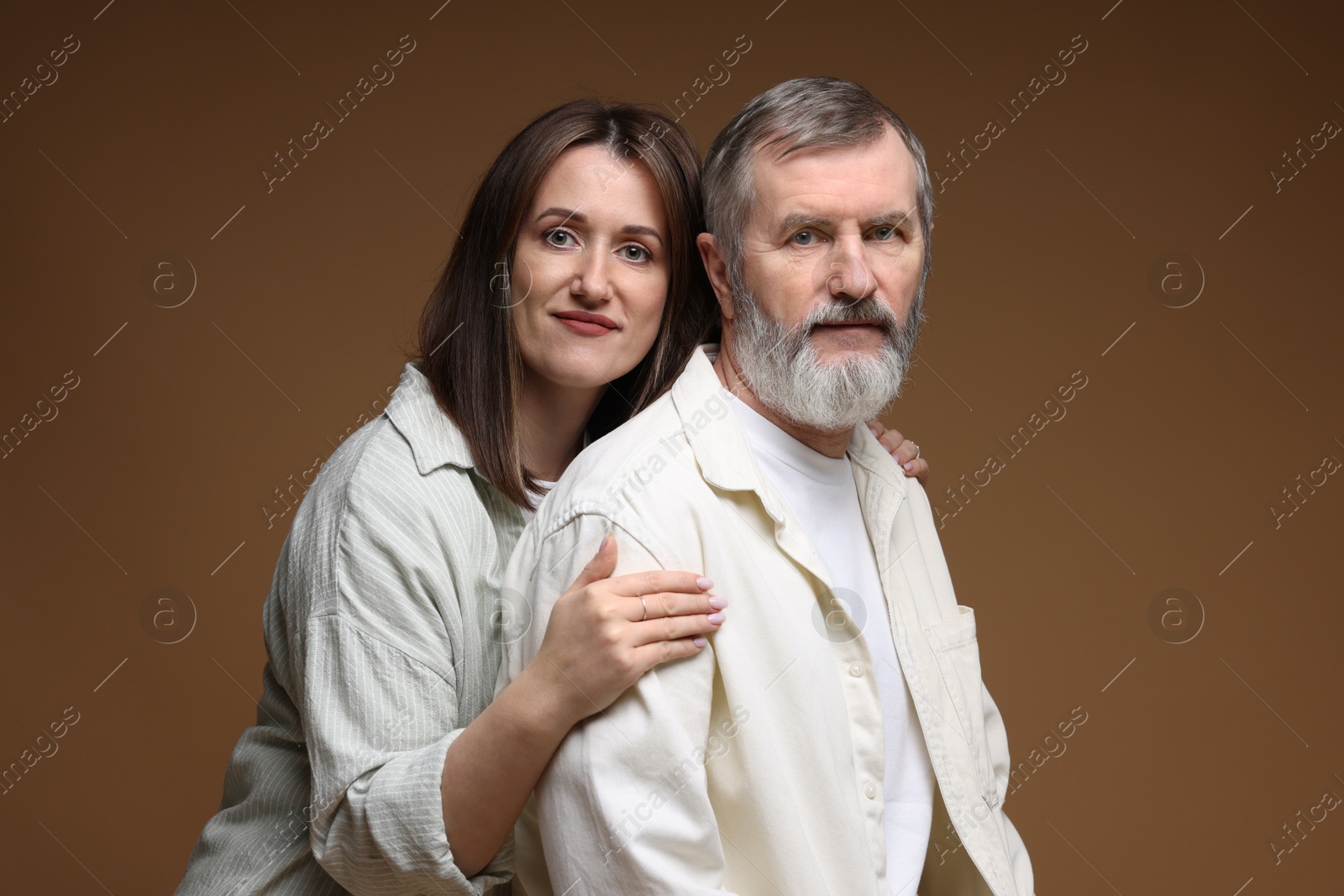 Photo of Family portrait of daughter and her father on brown background