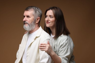 Photo of Daughter and her father on brown background