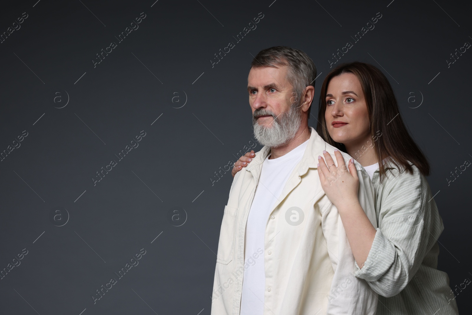 Photo of Daughter and her father on dark background, space for text