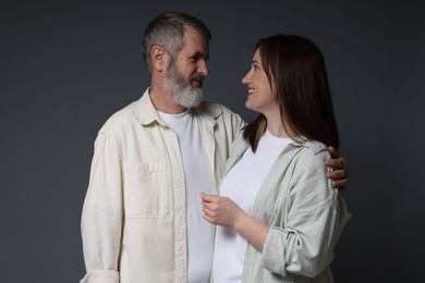 Photo of Happy daughter and her father on dark background