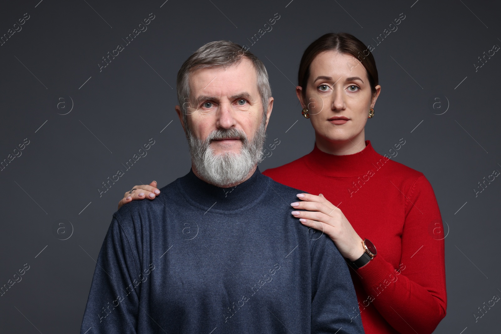 Photo of Family portrait of daughter and her father on dark background