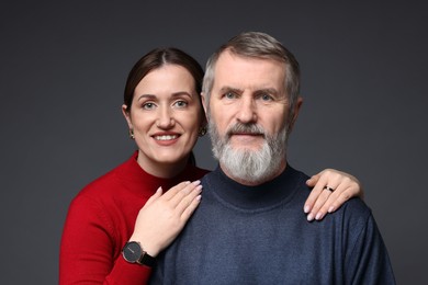 Photo of Family portrait of happy daughter and her father on dark background