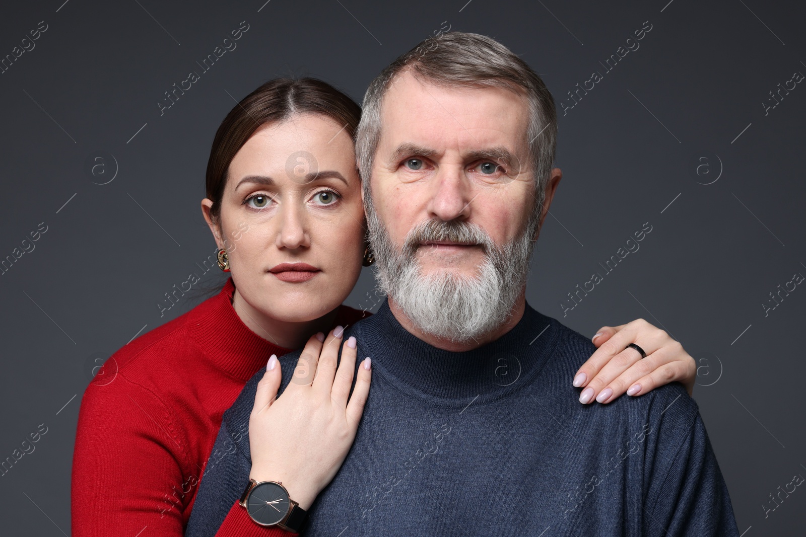 Photo of Family portrait of daughter and her father on dark background