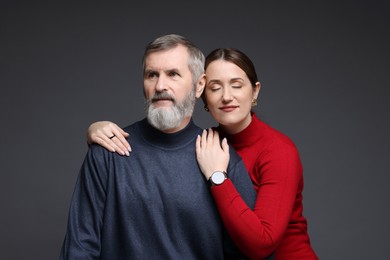 Daughter and her father on dark background