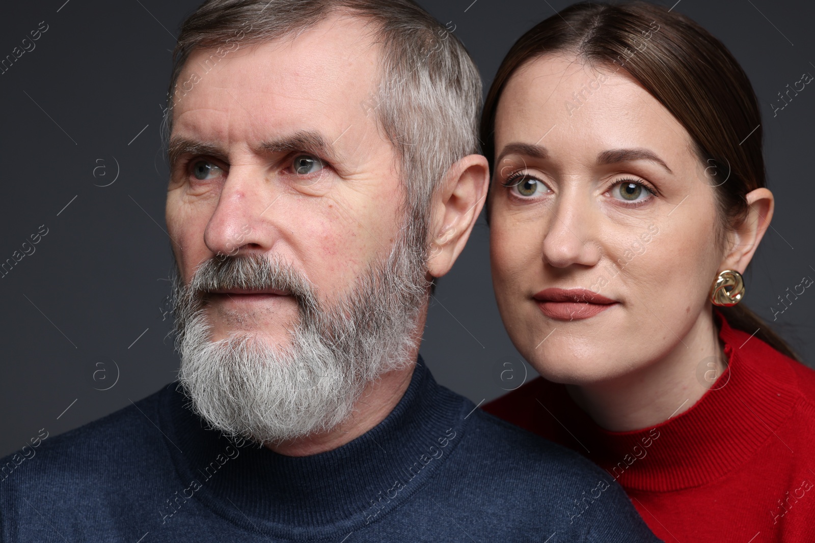 Photo of Daughter and her father on dark background, closeup