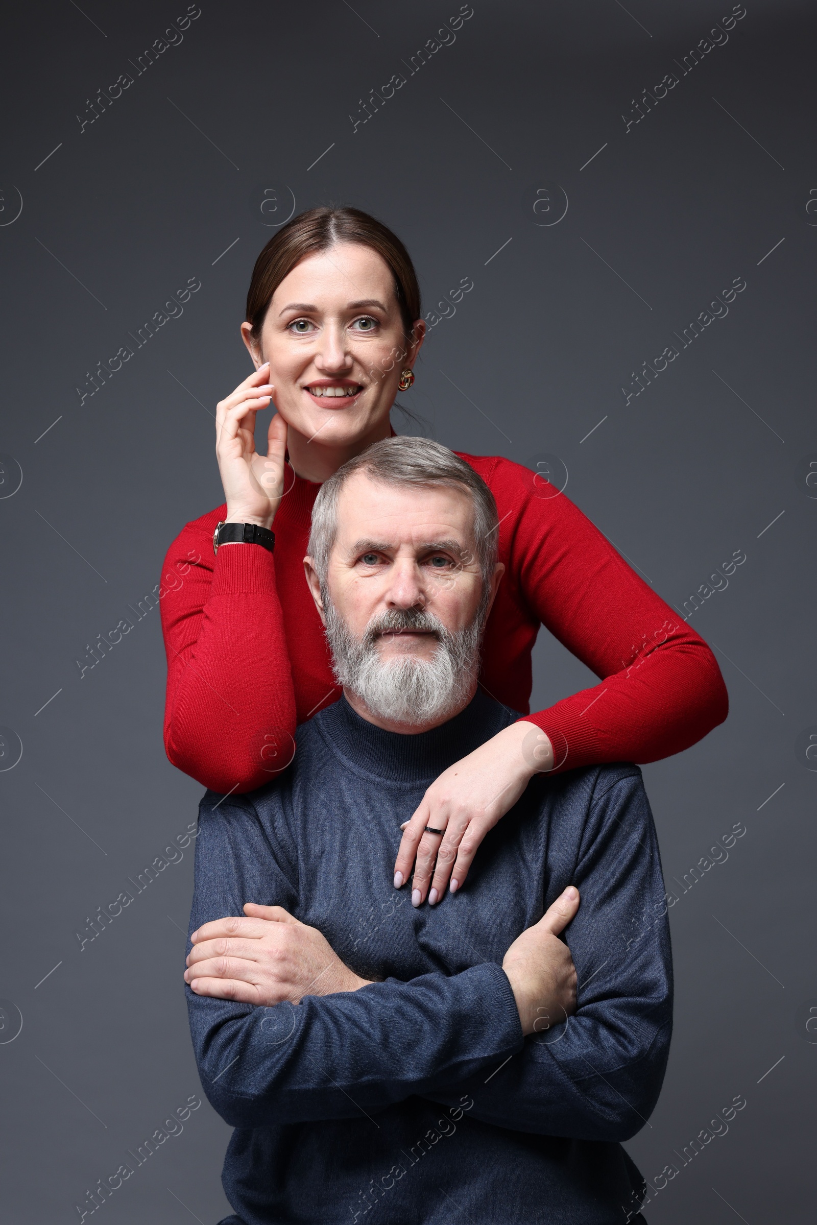 Photo of Family portrait of happy daughter and her father on dark background