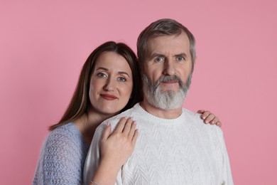 Photo of Family portrait of daughter and her father on pink background